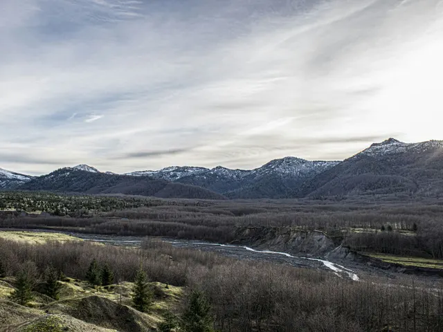 a view of a mountain range with a river in the foreground jigsaw puzzle