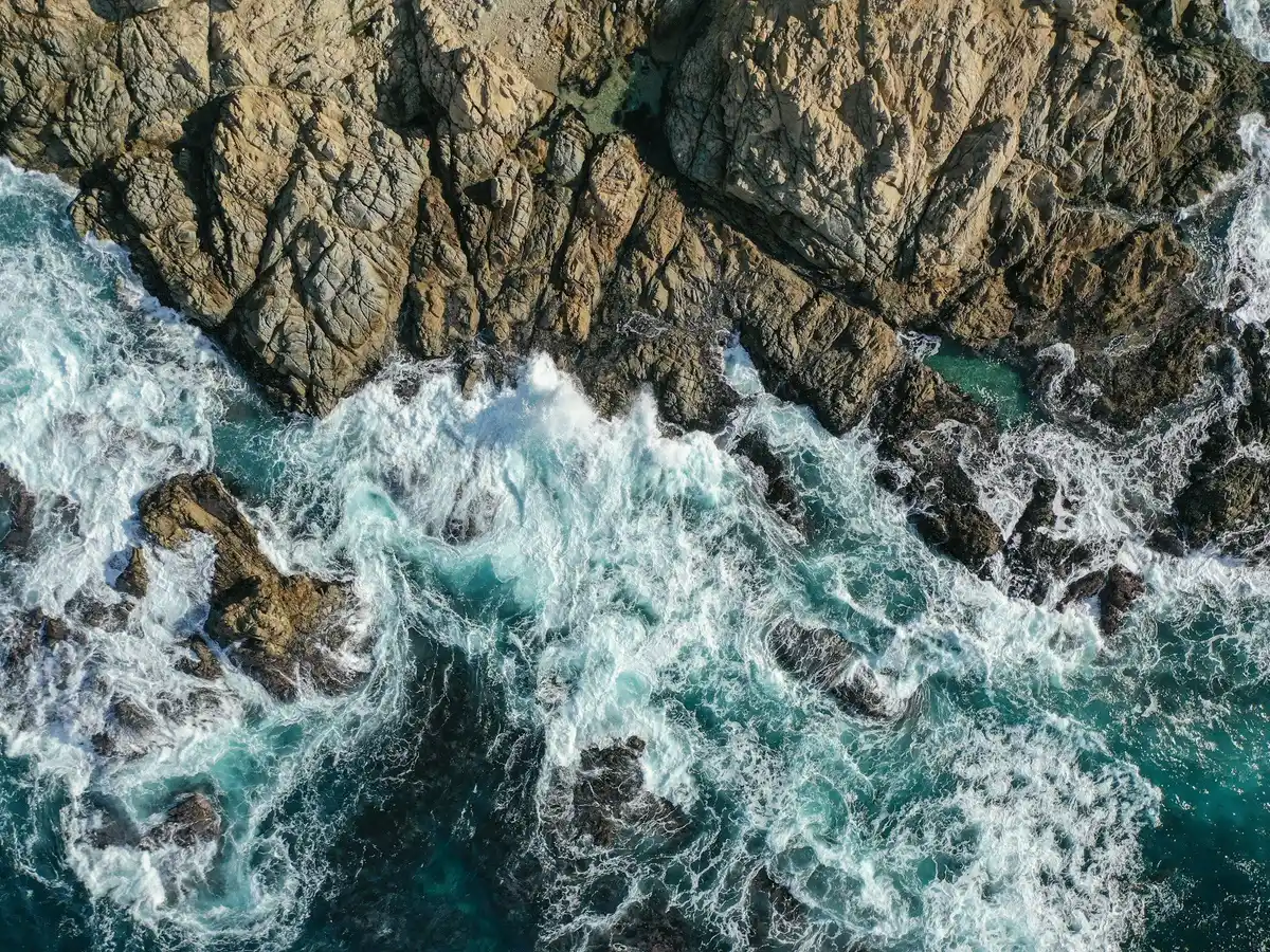 an aerial view of the ocean and rocks jigsaw puzzle