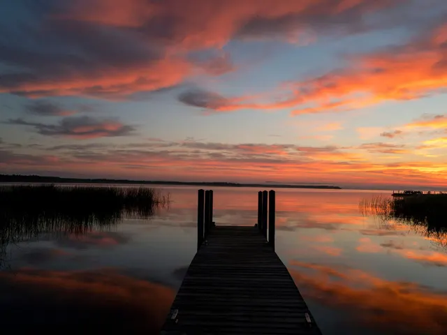 black wooden dock on body of water during golden hour jigsaw puzzle