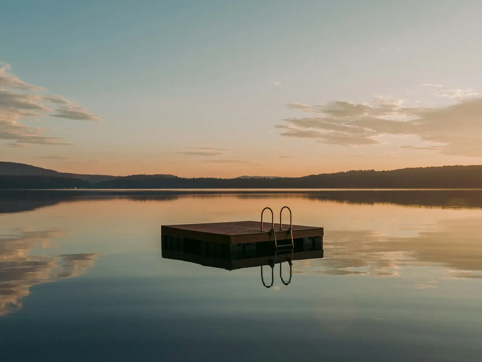 A wooden float is lit by the sunrise on a lake in Maine jigsaw puzzle