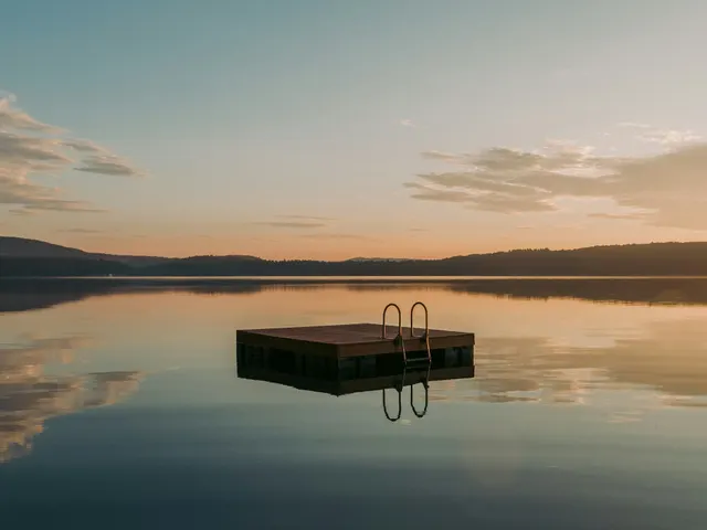 A wooden float is lit by the sunrise on a lake in Maine jigsaw puzzle