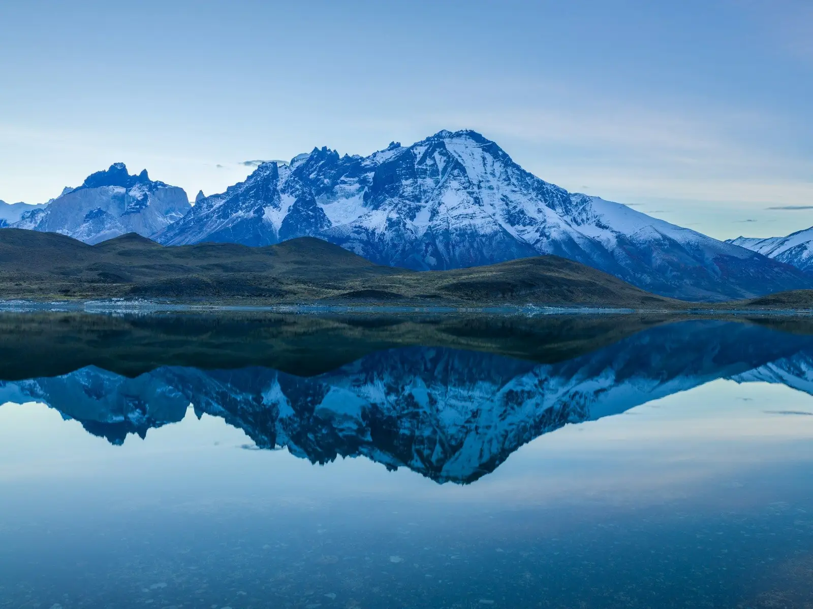Paine mountain range reflects in a lake before sunrise jigsaw puzzle