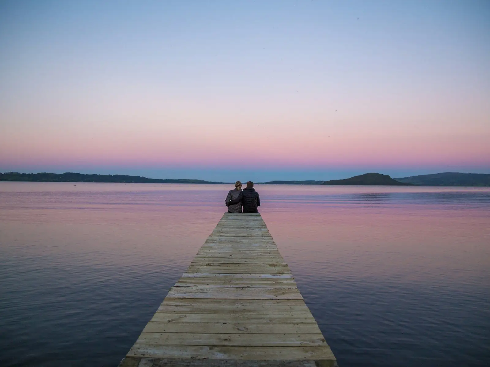 two persons sitting on ocean dock jigsaw puzzle