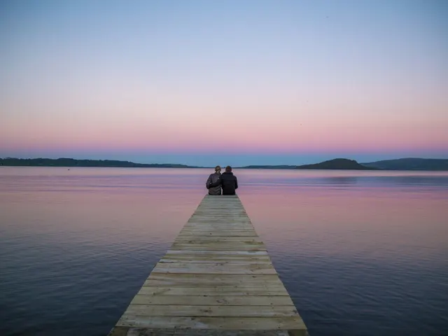 two persons sitting on ocean dock jigsaw puzzle