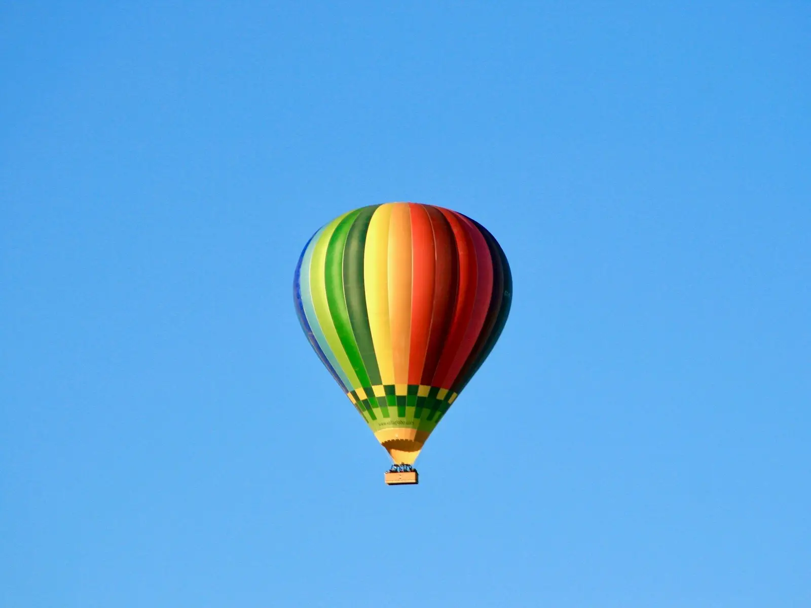 low angle photo of multicolored hot air balloon flying under blue skty jigsaw puzzle